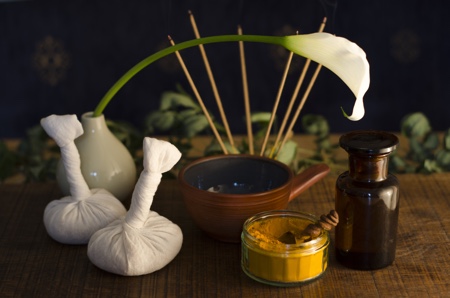 An arrangement of , spice, oil and massaging tools used in Ayurveda massage